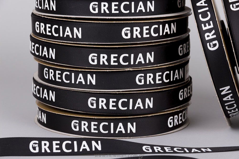 THE GRECIAN logo on ribbon