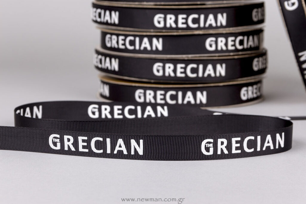 The Grecian logo on ribbon