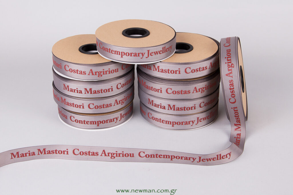 Grey gross robbon with red embossed silk screen printing with logo Maria Mastori Costas Argiriou Contemporary Jewellery