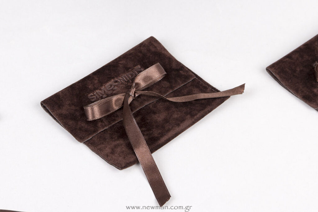 Brown suede pouches with brown satin ribbons and debossed logo
