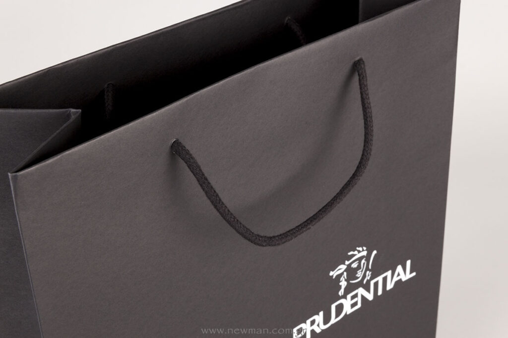 White silk-screen printing on black luxury paper bags