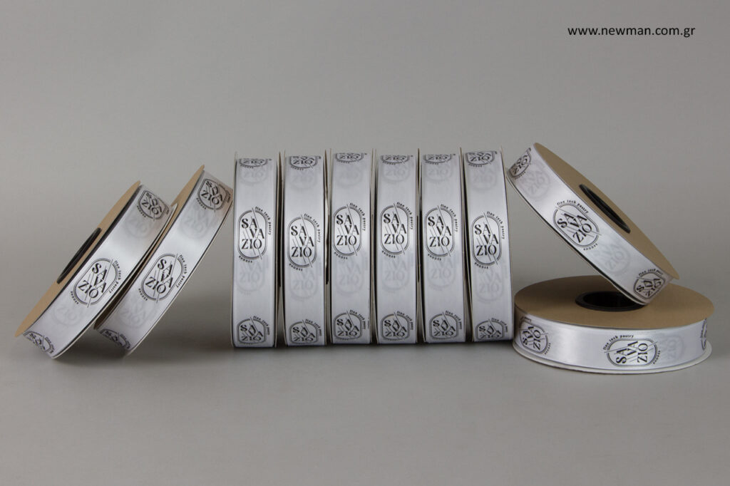 White wholesale ribbons with black printed logo.