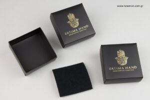 Fatima Hand:  Illuminated matte paperboard bijoux boxes with printed brand name.