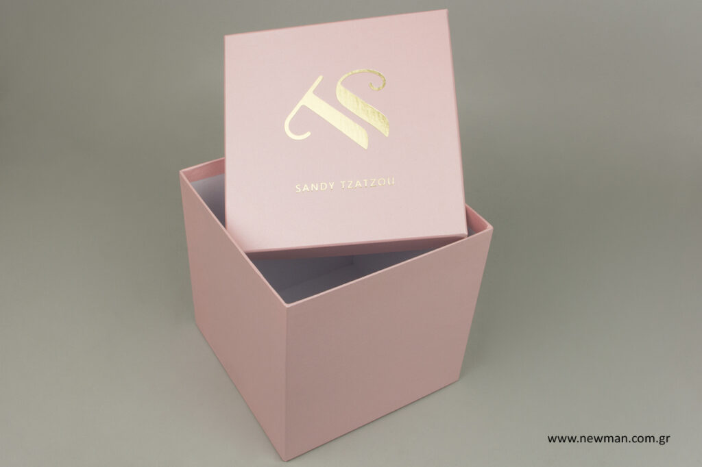 Sandy Tzatzou: Printed boxes with corporate brand name.