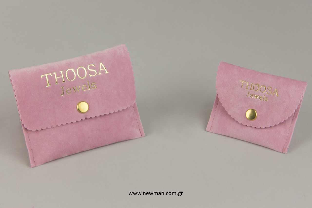 Pocket-shaped suede pouches with button and gold printing.