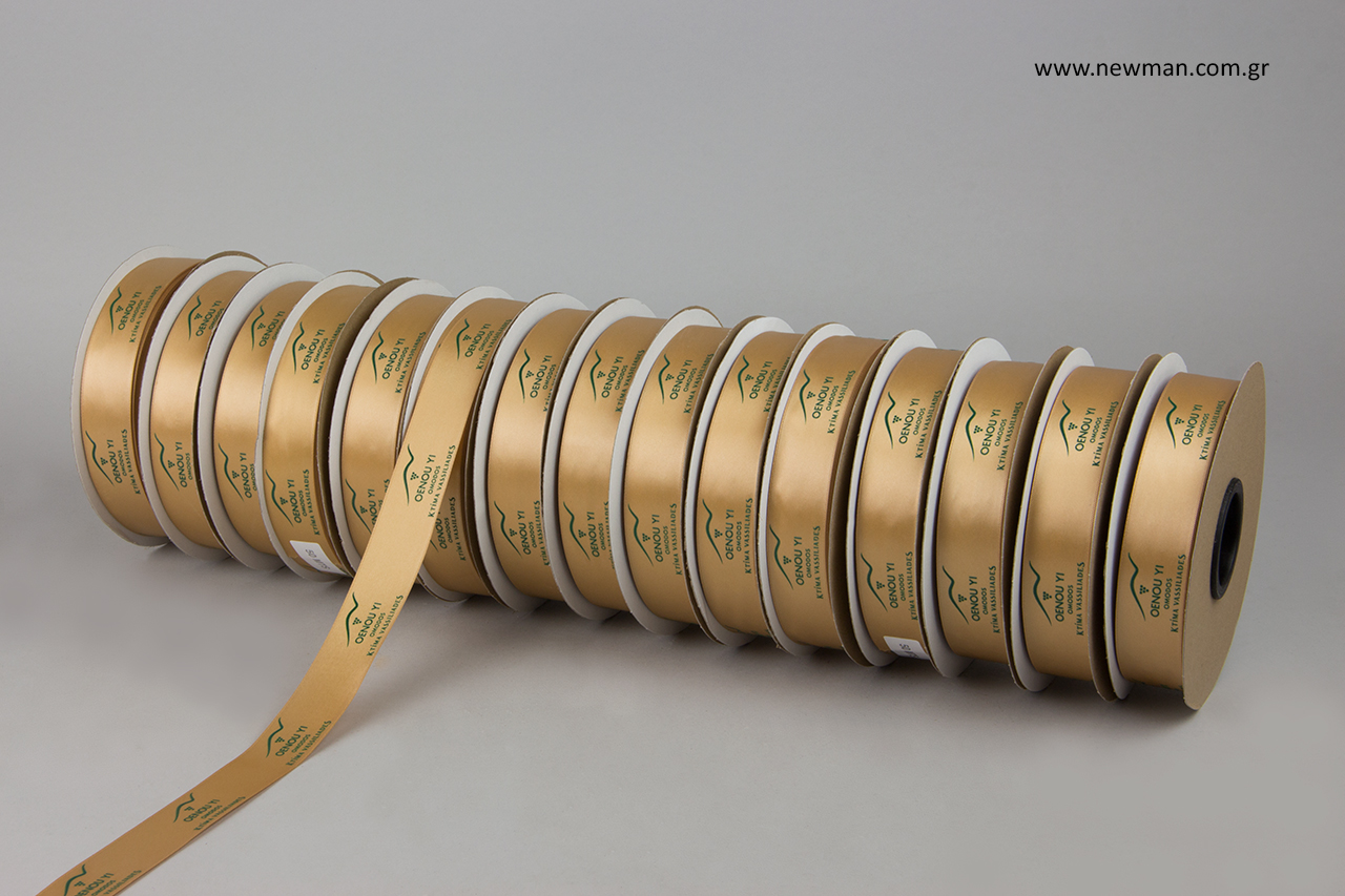 Gold double-faced luxury satin ribbon with embossed dark green printing.