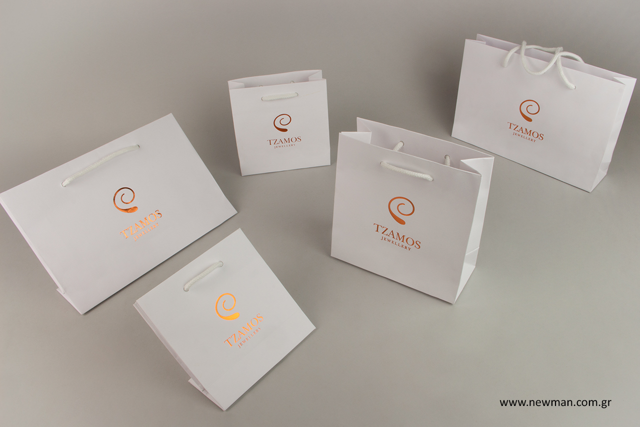 White branded gift bags with cotton rope handles.