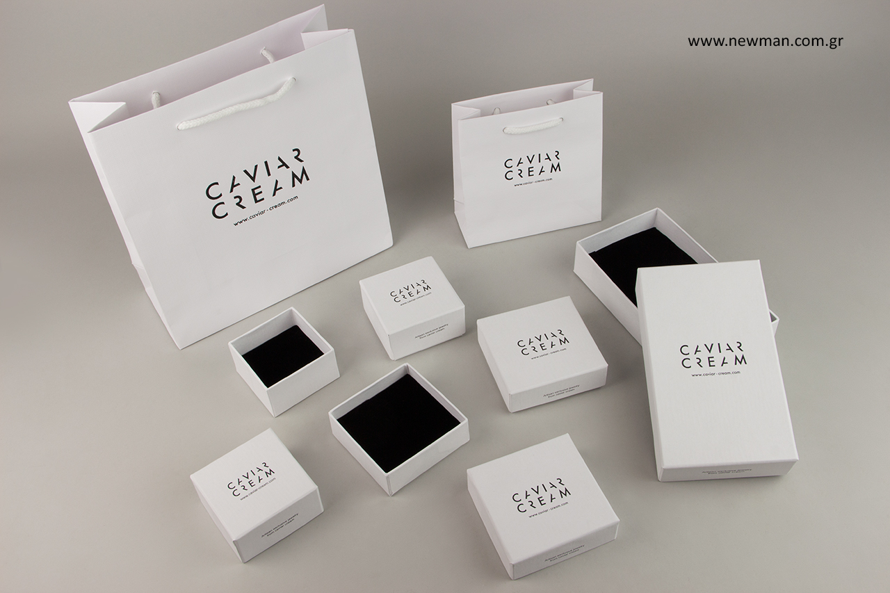 Luxury paper bags with hot-foil printed logo.