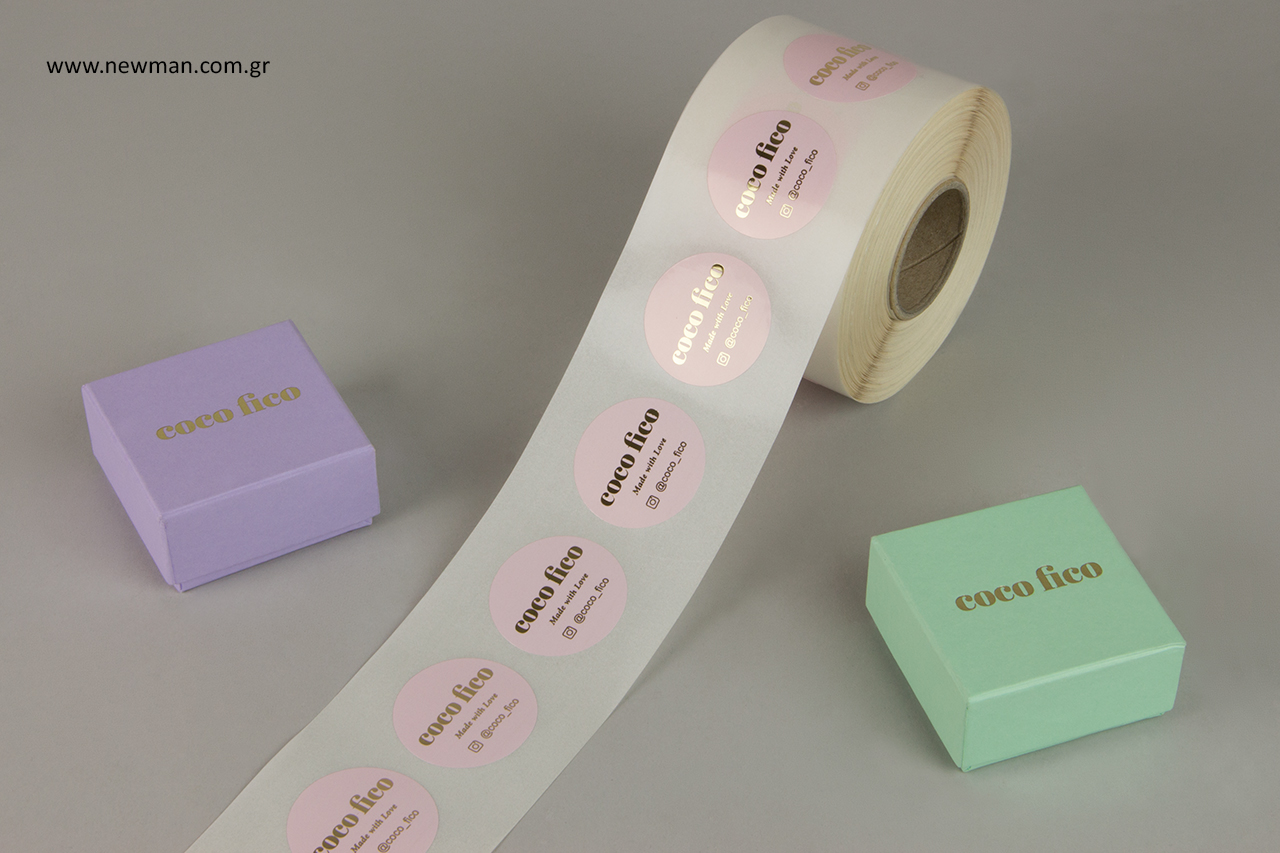 Jewelry boxes in pastel colors and pink labels with gold hot-foil printing.