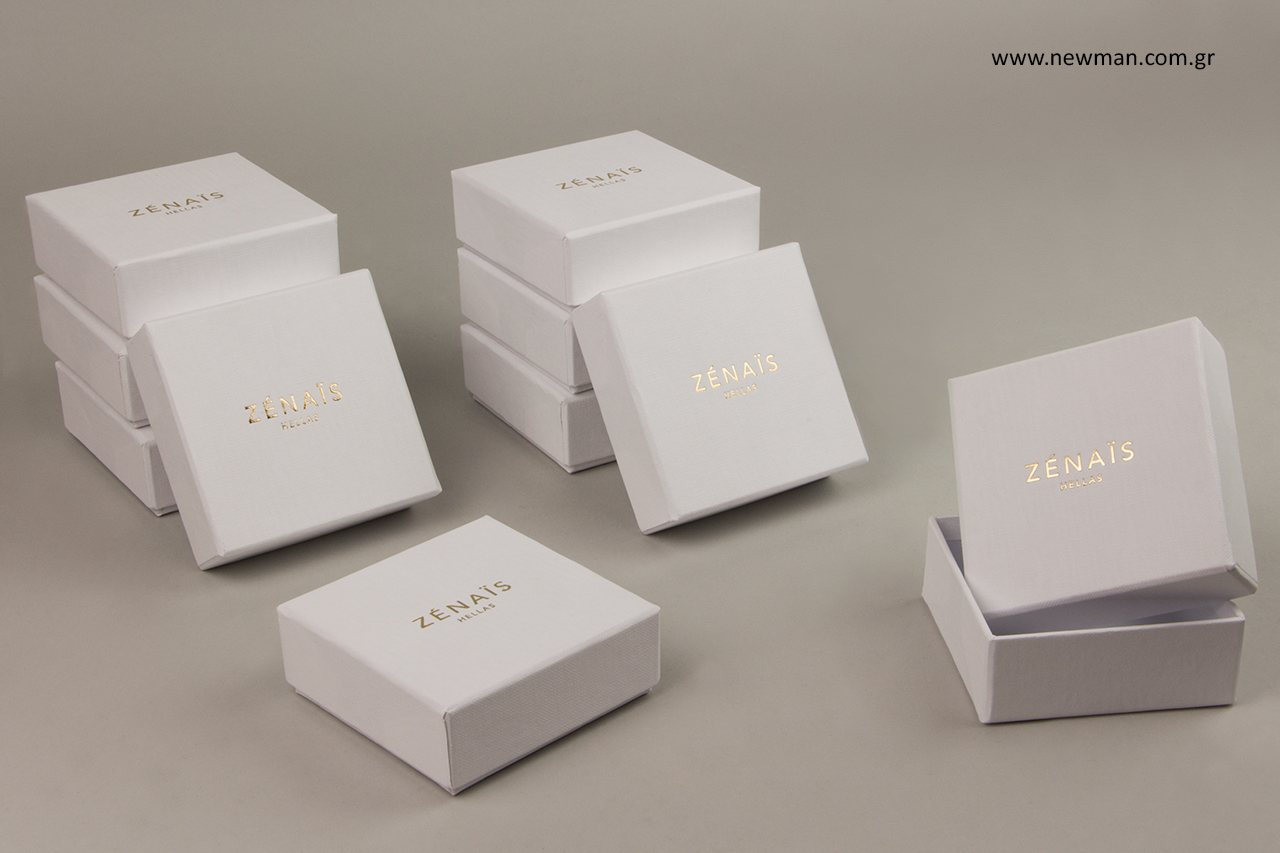 Jewellery boxes made of textured paper with printed logo.