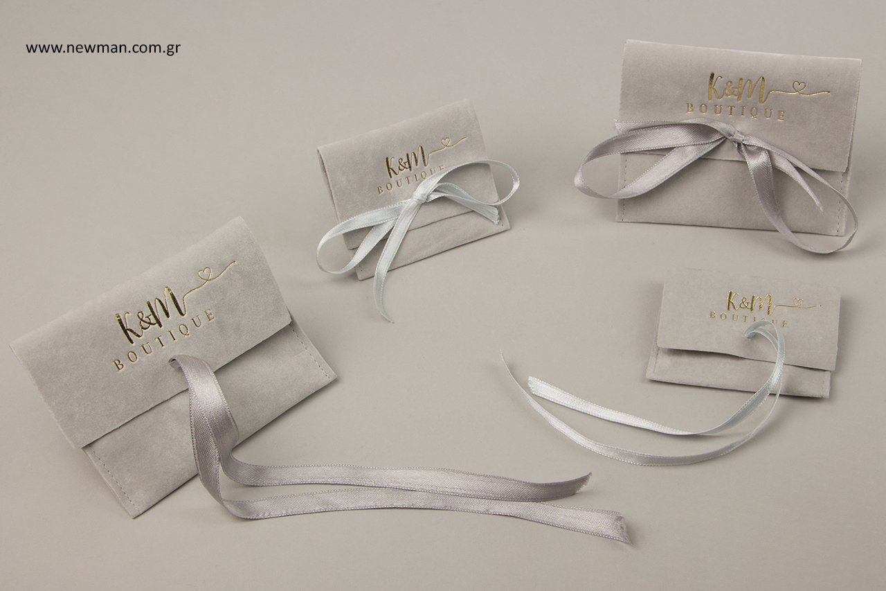 Branded suede pouches in light gray color for jewellery.