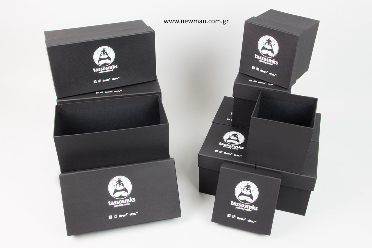 White hot-foil printing on black packaging boxes.