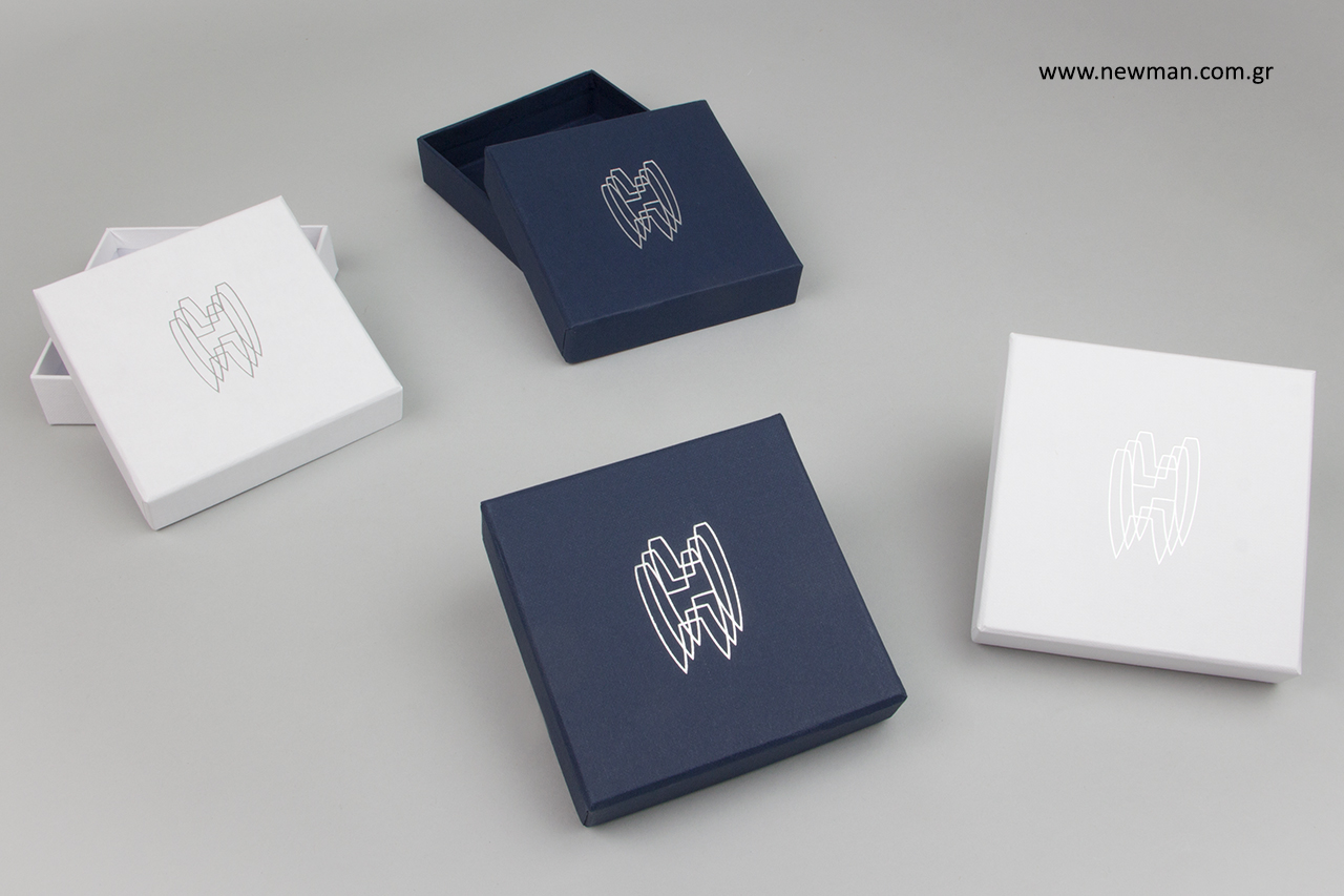 Silver hot-foil printing on textured paper boxes.