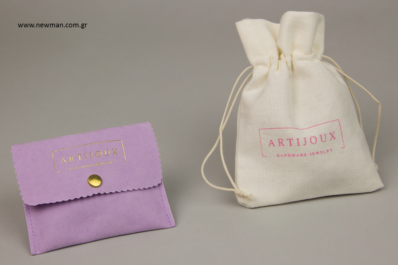 Cloth drawstring pouches with cord and suede pouches with button closure.