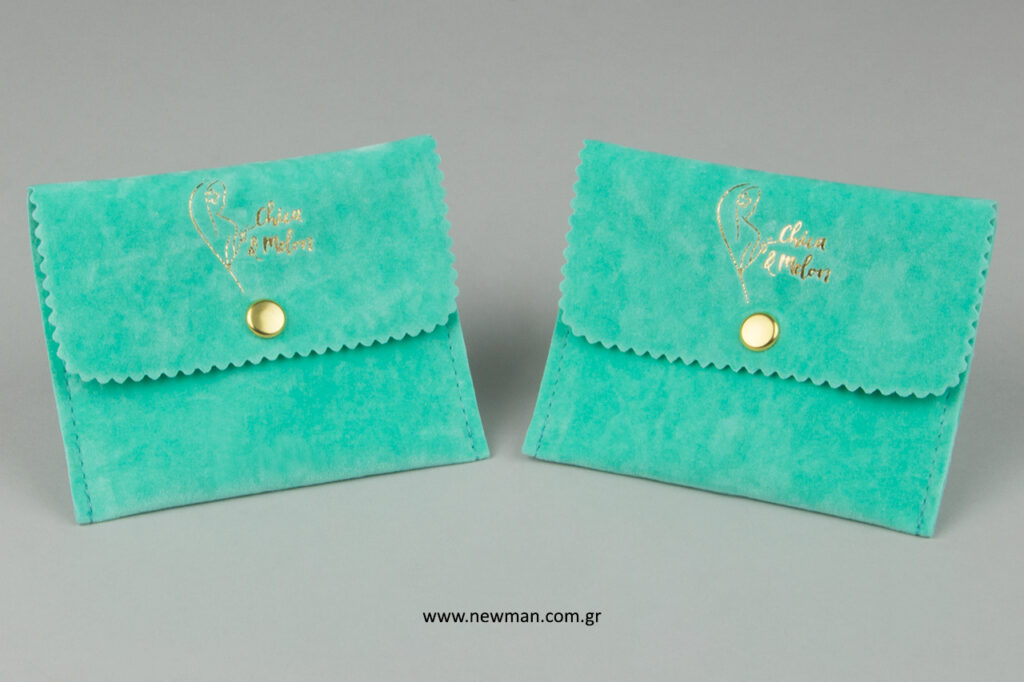 Chica & Melon: NewMan suede pouches with gold logo printing.