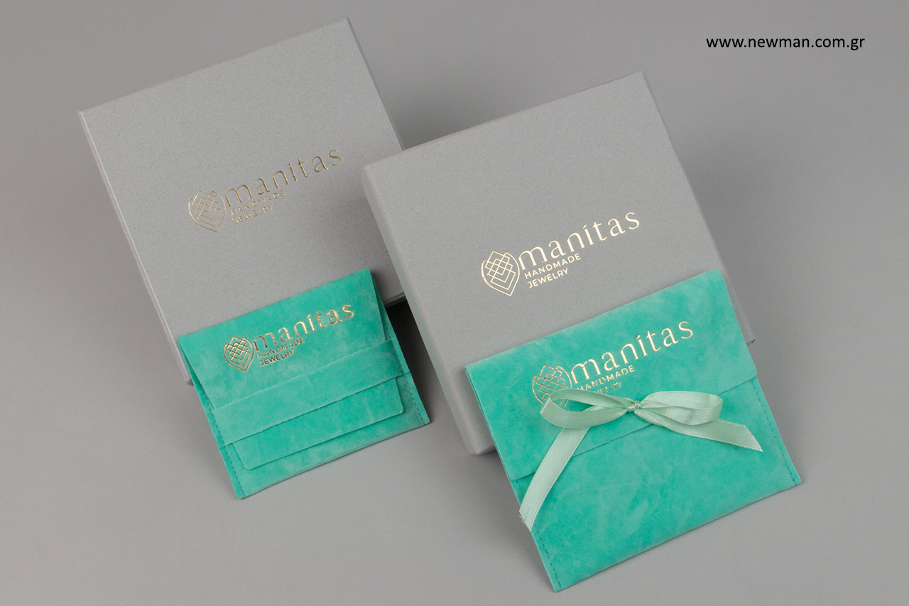 Suede pouches and paper boxes with gold hot-foil printing.