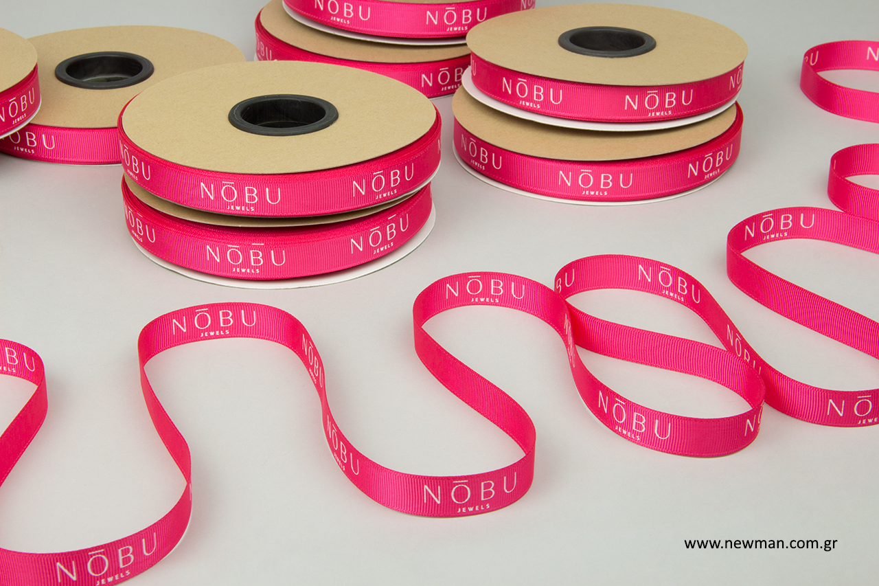 Wholesale decorative ribbons in fuchsia color with print.