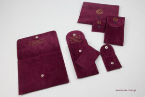 Gournelos jewellery: Suede pouch with button and gold printing.