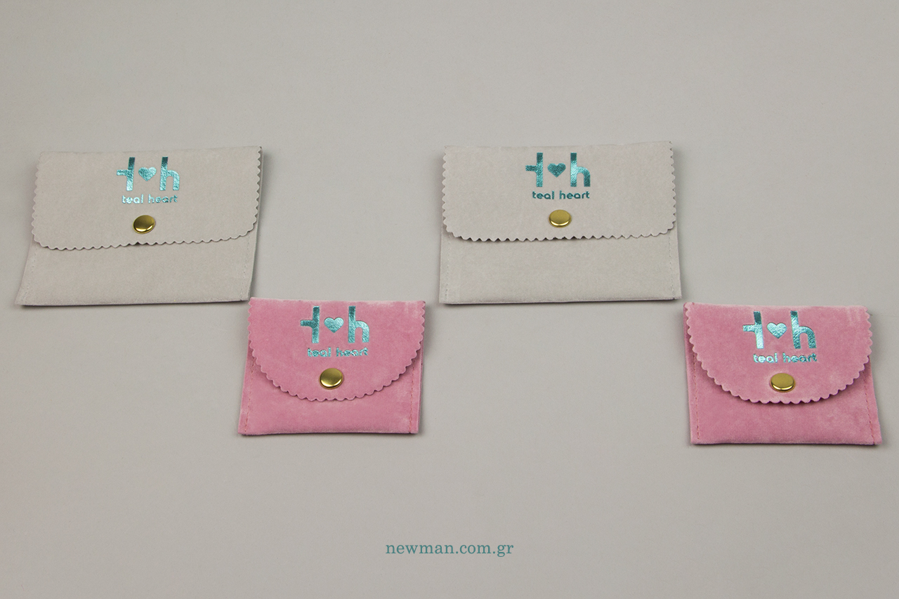 Turquoise hot-foil printing on suede packaging pouches.