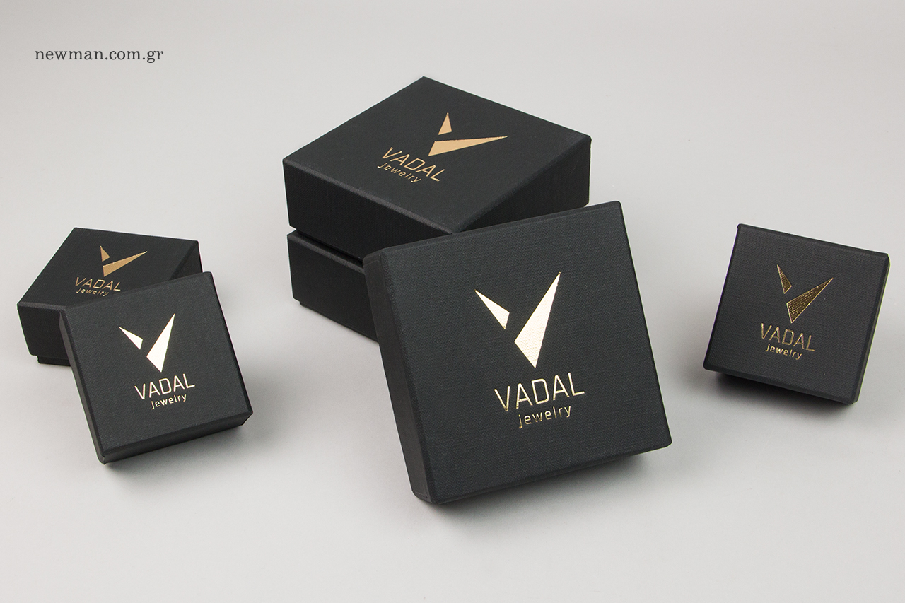 Black textured bespoke paper box with gold printing.
