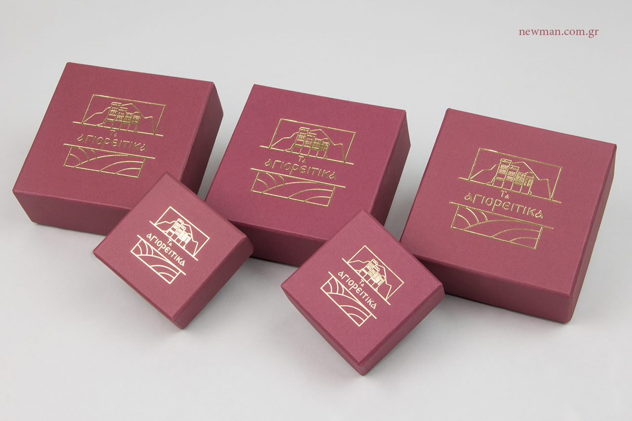 Gold hot-foil printing on red burgundy textured paper boxes.
