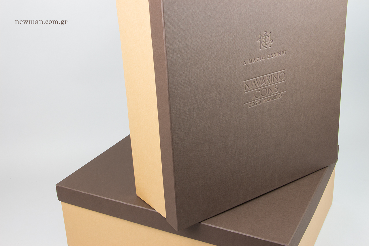 Deboss printing on rigid boxes with the logo of A Magic Cabinet & Costa Navarino.