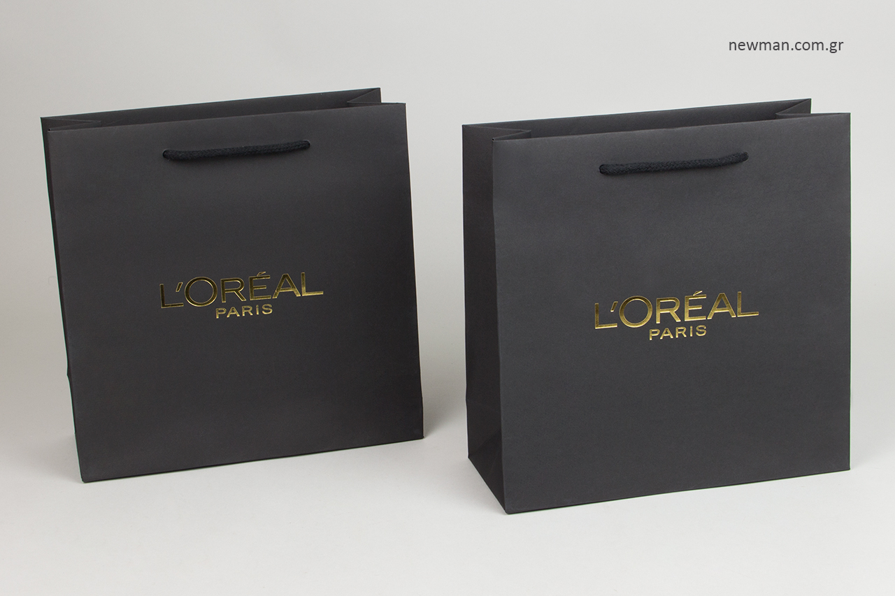 Χάρτινες τσάντες NewMan με το λογότυπο L’Oréal Paris.