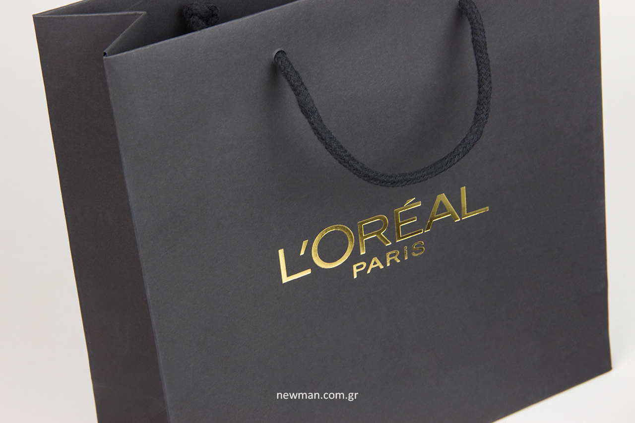 L’Oréal Paris: Newman είδη συσκευασίας με λογότυπο.
