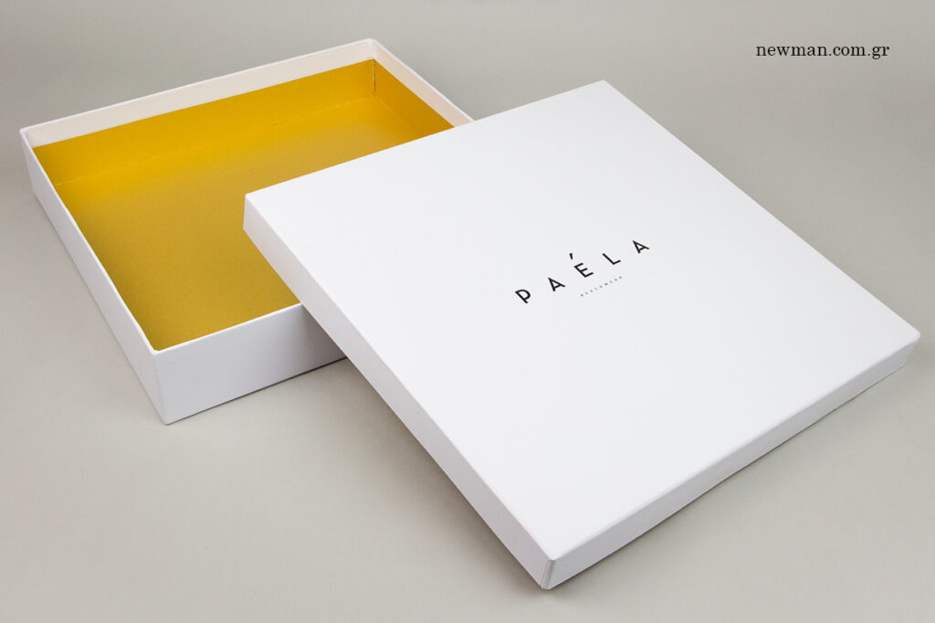 Paela Beachwear: Paper packaging boxes with black hot-foil printing.