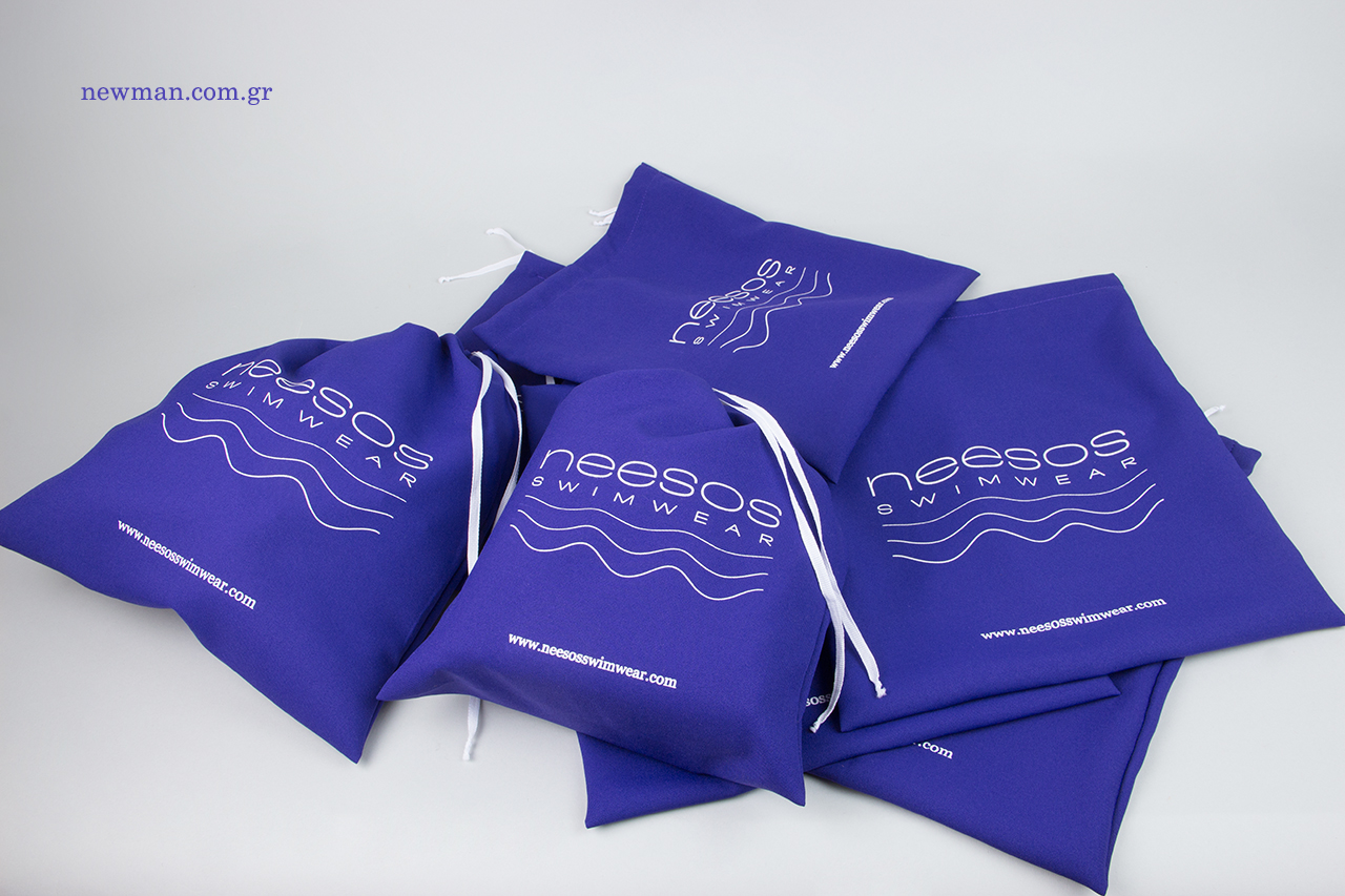 White silk-screen printing on cloth swimwear packaging.