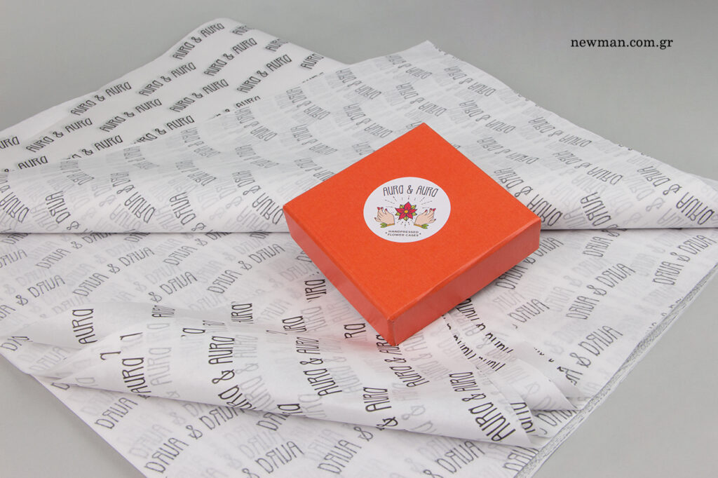 Aura & Aura: NewMan printed packaging with logo.