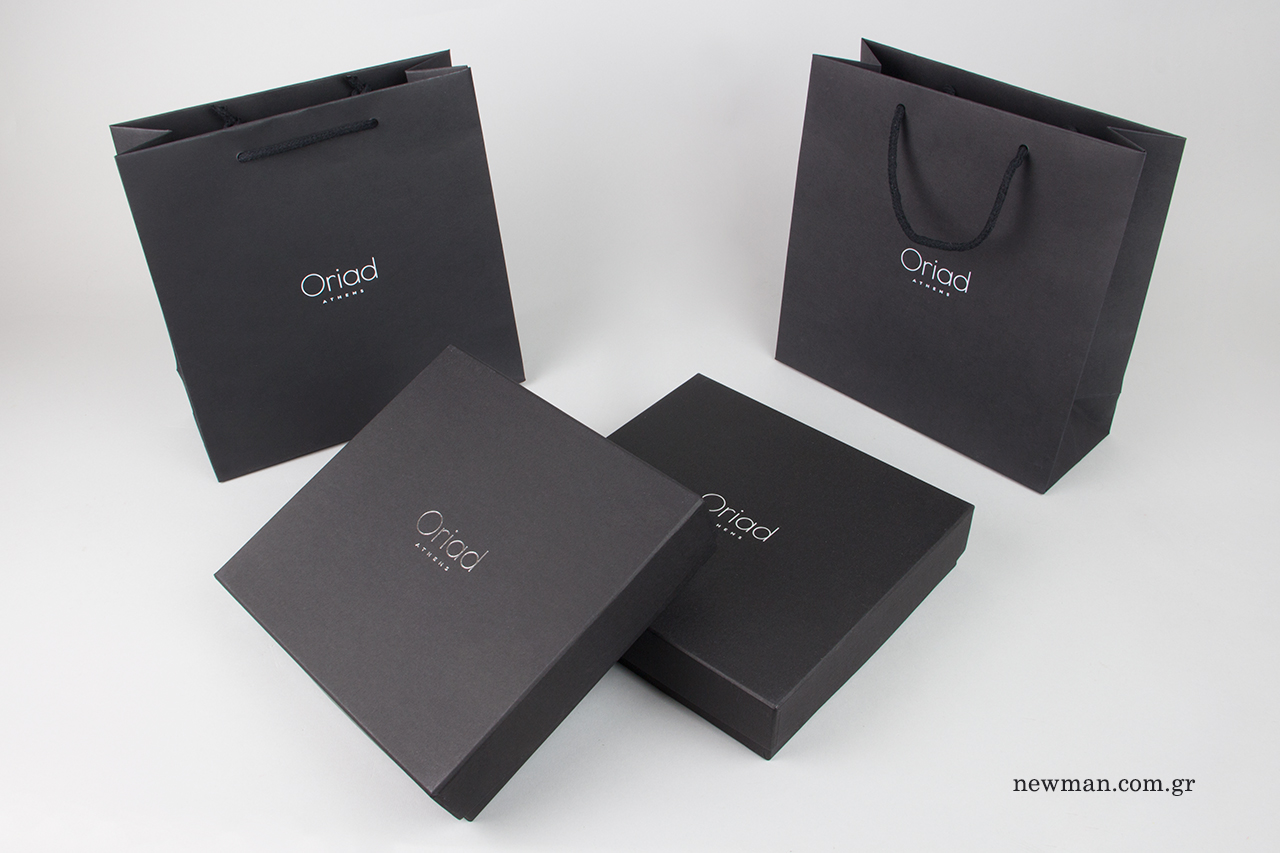 Luxury packaging with silver hot-foil logo printing.