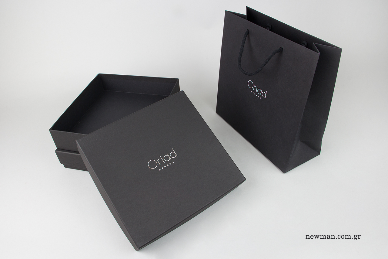 Paper bags and gift boxes with silver print.