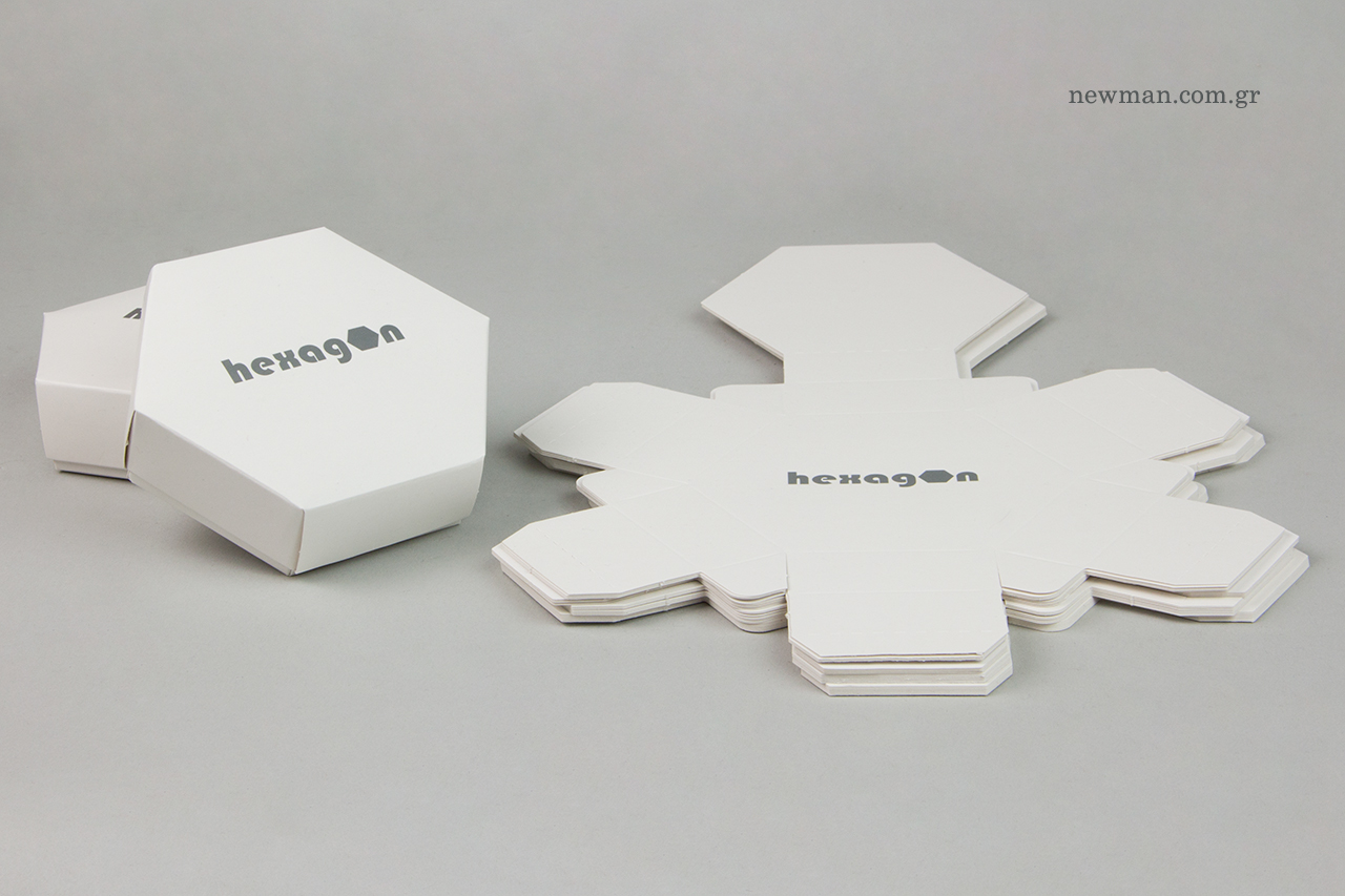 Cool gray embossed printing on hexagon-shaped boxes.