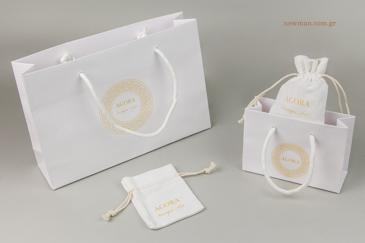 Gold silk-screen printing on Gofrato luxury paper bag and on cloth drawstring pouch.