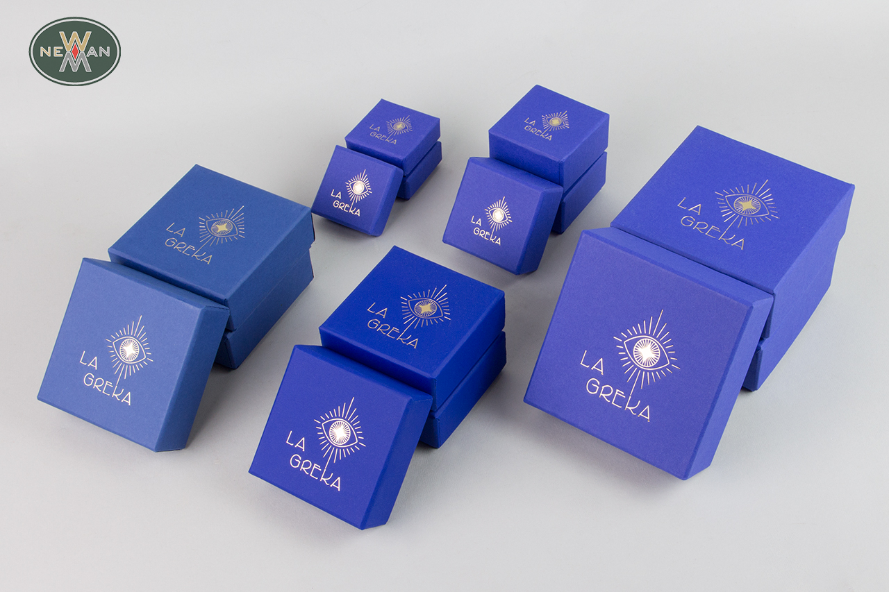 Blue handmade rigid jewellery boxes with gold logo.