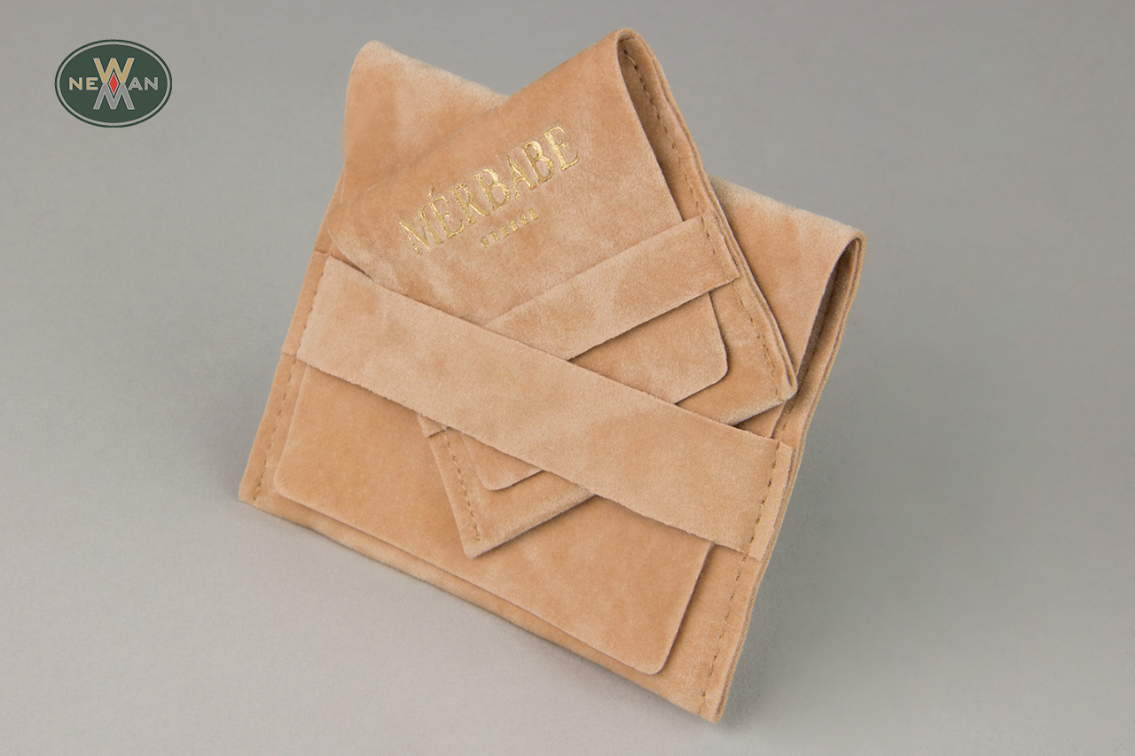 Suede pocket pouches with gold hot-foil printing.