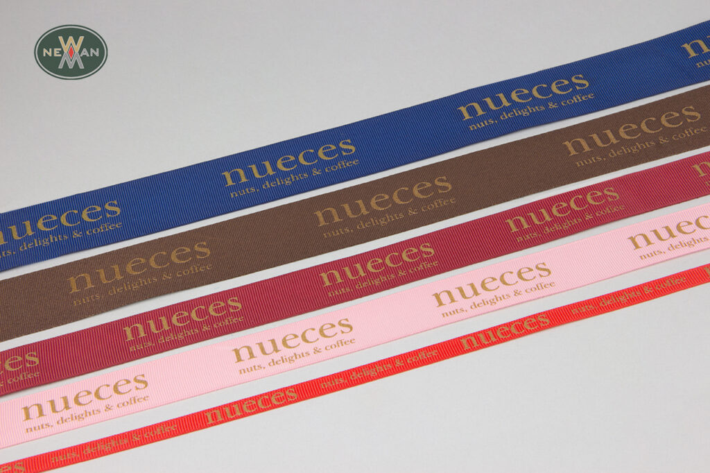 Nueces: Corporate logo print on a grosgrain ribbon.